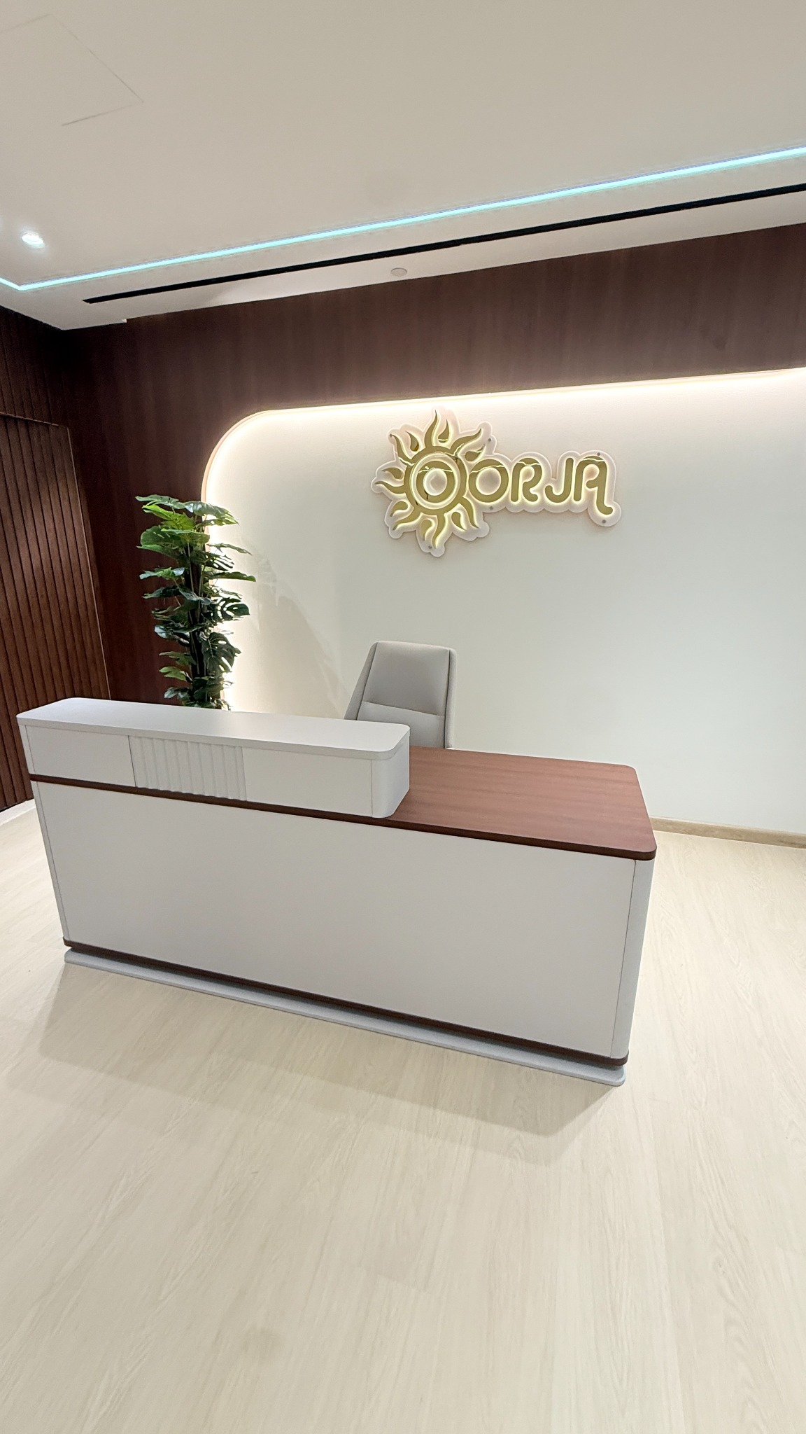 Original Oorja reception with dark timber and off-white counter